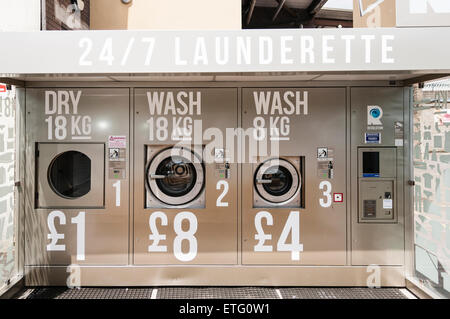 Automatic outdoor launderette allowing people to dry and wash clothes. Stock Photo