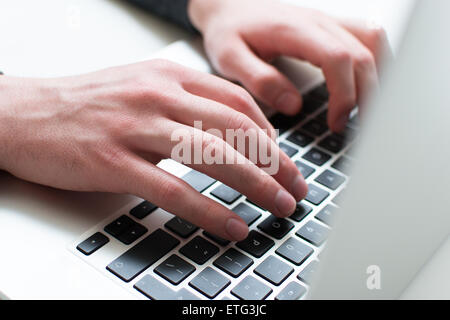 A man typing on his laptop Stock Photo