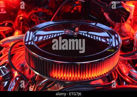 New York, USA. 12th June 2015. Under an open hood, the engine of a red 1972 Pontiac Convertible Le Mans Sport is lit up in red at the Friday Night Car Show held at the Bellmore Long Island Railroad Station Parking Lot. Hundreds of classic, antique, and custom cars were on view at the free weekly show, sponsored by the Chamber of Commerce of the Bellmores. Stock Photo