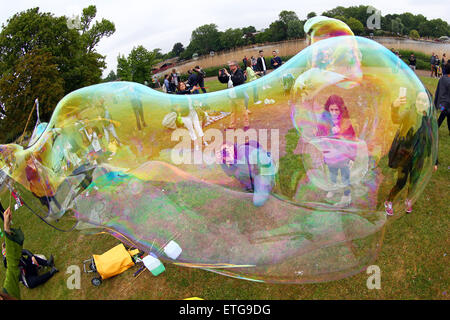 London, UK. 13th June 2015. People blowing bubbles at the LON-BUBBLE-DON International Give a Bubble Day, a bubble blowing Flash Mob in Hyde Park, London where the kids had a great time Credit:  Paul Brown/Alamy Live News Stock Photo