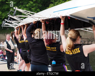 Durham, UK. 13th June, 2015. Competitors lifting their boat into the water during the 182nd Durham Regatta. Durham Regatta is the second oldest in the country, preceded only by Chester Regatta. Today, the regatta takes place over a 750m ‘short course’ on the scenic River Wear in Durham City, and regularly attracts in excess of two thousand competitors and ten thousand spectators from across the United Kingdom. Credit:  AC Images/Alamy Live News