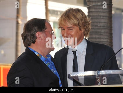 LOS ANGELES, CA - NOVEMBER 1, 2011: John Lasseter & Owen Wilson (right) on Hollywood Boulevard where Lasseter was honored with the 2,453rd star on the Hollywood Walk of Fame. November 1, 2011 Los Angeles, CA Stock Photo