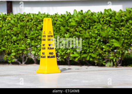 Yellow sign caution wet floor. Outdoors Stock Photo