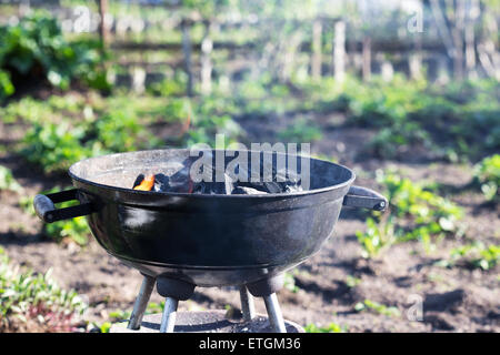 Burning charcoal in barbecue, outdoors Stock Photo