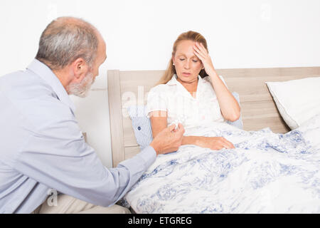 Giving medication to an elderly woman Stock Photo