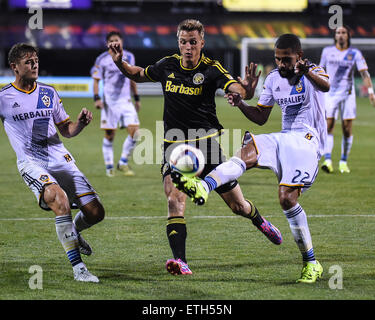 Columbus, Ohio, USA. 13th June, 2015. Los Angeles Galaxy defender Leonardo (right) Columbus Crew SC forward Aaron Schoenfeld (center) and Los Angeles Galaxy midfielder Robbie Rogers (left) fight for the ball during a regular season match between  Columbus Crew SC and the Los Angeles Galaxy at Mapfre Stadium in Columbus, Ohio. Credit:  Brent Clark/Alamy Live News Stock Photo