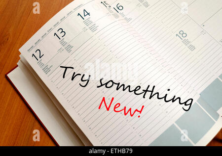 Business Notepad on wooden table Try something new concept Stock Photo
