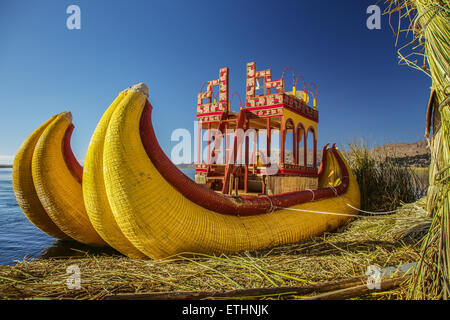 Reed boat on Island of Uros. Those are floating islands on lake Titicaca located between Peru and Bolivia. Colorful image with y Stock Photo