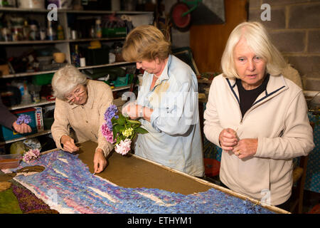 UK, England, Derbyshire, Eyam, volunteers constructing the Requisitioning of Horses 2014 well dressing Stock Photo