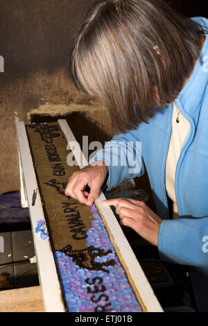 UK, England, Derbyshire, Eyam, volunteer constructing the Requisitioning of Horses 2014 well dressing Stock Photo