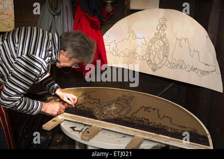 UK, England, Derbyshire, Eyam, volunteer constructing the Requisitioning of Horses 2014 well dressing Stock Photo