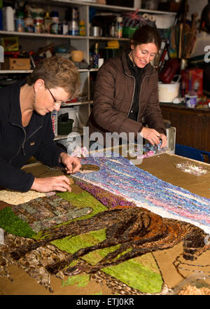 UK, England, Derbyshire, Eyam, volunteers petalling the Requisitioning of Horses 2014 well dressing, to be blessed Wakes Week Stock Photo