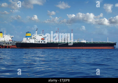crude oil tanker is loading in the port on the background of clouds Stock Photo