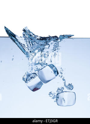 Falling ice cubes in water splashes isolated on white background Stock Photo