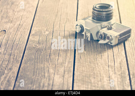 vintage photo shot of camera on old wooden table Stock Photo