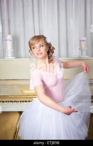 Young beautiful ballerina posing in dance studio Stock Photo