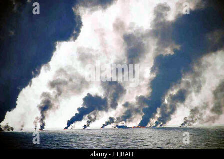 Dark clouds fill the sky as shrimp boats use a boom to gather crude oil during a controlled surface burn following the BP Deepwater Horizon oil spill disaster as efforts to contain and clean the millions of gallons of crew continue June 19, 2010 in the Gulf of Mexico. Stock Photo