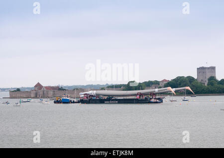 Portsmouth, UK. 14th June, 2015. Three 100m free-standing masts being transported by barge for a client in Germany from Magma in Portsmouth Harbour. 14th June. Credit:  Rob Wilkinson/Alamy Live News Stock Photo