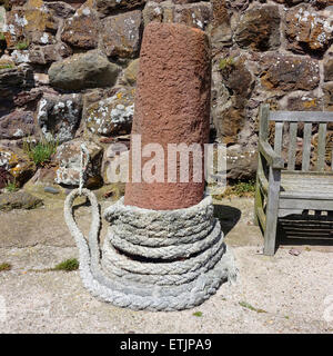 Old stone bollard and rope in North Berwick harbour Stock Photo