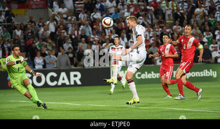 Faro, Portugal. 13th June, 2015. Germany's Andre Schuerrle (C) misses an opportunity to score a goal against Gibraltar's goalkeeper Jordan Perez (L) and Ryan Casciaro and Roy Chipolina (R) during the UEFA EURO 2016 qualifying group D soccer match Gibraltar vs. Germany at the Algarve Stadium in Faro, Portugal, 13 June 2015. Photo: Arne Dedert/dpa/Alamy Live News Stock Photo