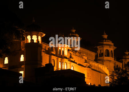 Night view across part of Lake Pichola to the City Palace, Udaipur, Rajasthan, India Stock Photo
