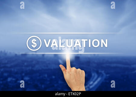 hand pushing financial valuation button on a virtual screen interface Stock Photo