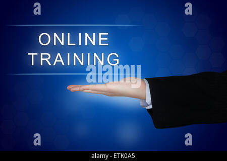 online training button with business hand on blue background Stock Photo