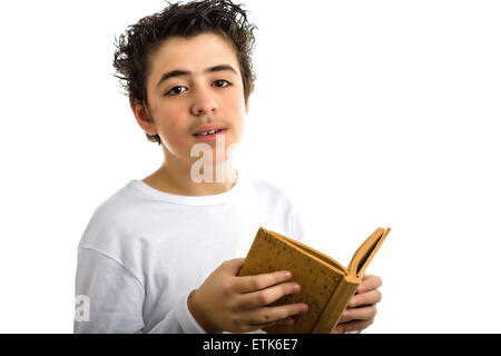 A handsome Hispanic boy reads with serene eyes a brown blank book made with cork Stock Photo