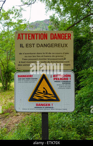 Warning sign in French about danger of flooding river Stock Photo