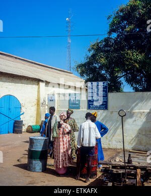 Gambian people in front of NTC building, the National Trading Corporation of Gambia, Banjul, Gambia, West Africa Stock Photo