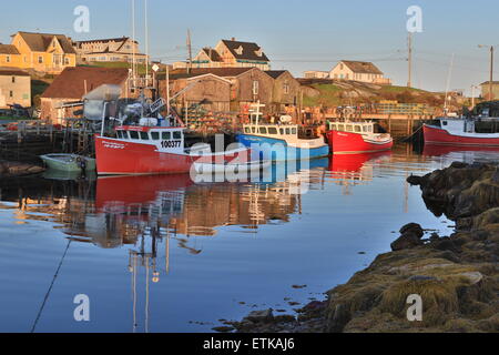 Nova Scotia Peggys Cove, Canada fishing village with lobster boats in morning light. Stock Photo