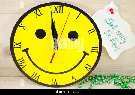 Smiley clock showing a minute to twelve Stock Photo