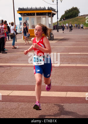 Portsmouth, UK. 14th June, 2015. A young athlete taking part in the the under 16 triathlon approaches the finish line of the Portsmouth Try a tri triathlon. The event consisted of a number of sprint triathlons of different lengths to accomodate differing abilities. Credit:  simon evans/Alamy Live News Stock Photo