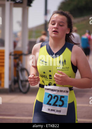 Portsmouth, UK. 14th June, 2015. A young athlete approches the finish line of  the Portsmouth Try a tri triathlon. The event consisted of a number of sprint triathlons of different lengths to accomodate differing abilities. Credit:  simon evans/Alamy Live News Stock Photo