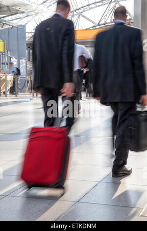 Businesspeople rushing through corridor, motion blur Stock Photo