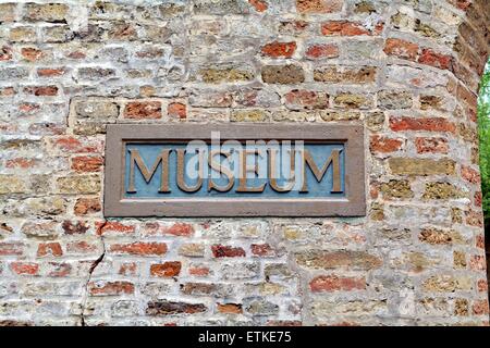 Close up of a museum sign made in stone on a brick wall Stock Photo