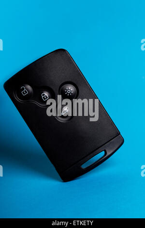 Close up view of a modern card car key isolated on a blue background. Stock Photo