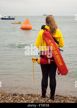 A RLSS or Royal Life Saving life guard stands watch near to the sea on ...