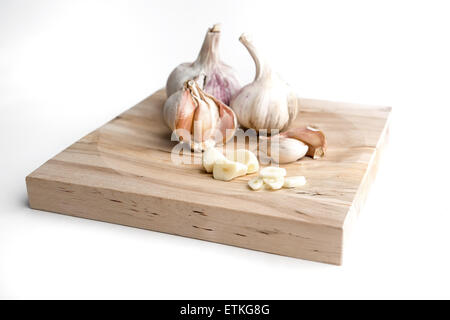 Garlic over wood board on white background. Stock Photo