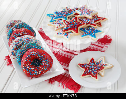 Cookies and donuts decorated with icing and sprinkles in red, blue, and white to celebrate 4th of July in America. Stock Photo