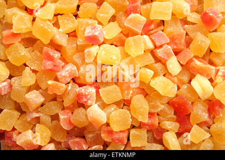 Dried pineapple and papaya pieces as an abstract background texture Stock Photo