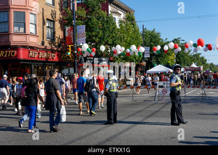 Police officers direct traffic and pedestrians at the sixth annual Italian Day celebrations on Commercial Drive in Vancouver, British Columbia Stock Photo