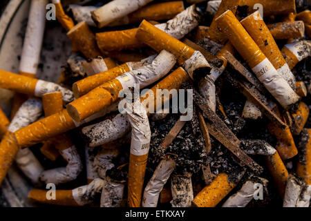 Full ash tray of cigarette butts Stock Photo