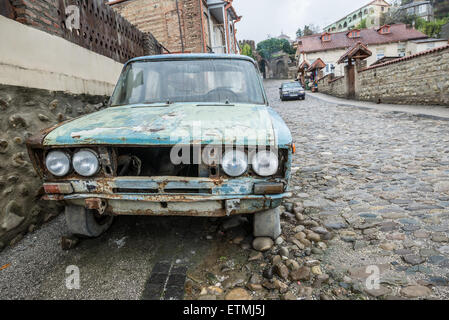 Old rusty VAZ 2106 (Lada 1600) car in small town Sighnaghi in Kakheti region of Georgia Stock Photo