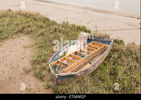 marooned sailing boat boats raised up on silty mud and sand at low tide on backwaters of estuary at he Hythe Quay Maldon Stock Photo