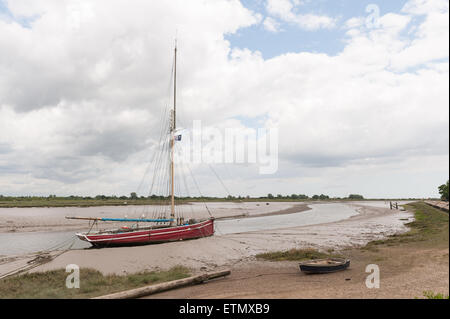 marooned sailing boat boats raised up on silty mud and sand at low tide on backwaters of estuary at he Hythe Quay Maldon Stock Photo