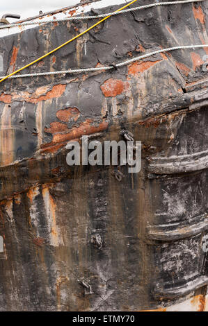Deteriorating rusty hull of Steam Tug Brent in need of repair moored at The Backwater Quay Stock Photo
