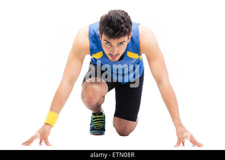 Sports man getting ready to run isolated on a white background. Looking at camera Stock Photo
