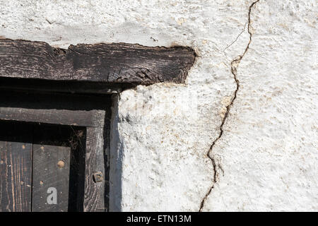 crack in old barn,Wall - Building Feature.Straw Textured.Cob.Rough.Built Structure.Clay.Environment.Nature.Building Exterior.Gra Stock Photo