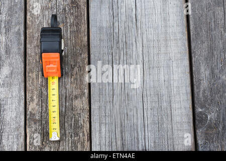 Measuring tape on a wooden board with copyspace Stock Photo